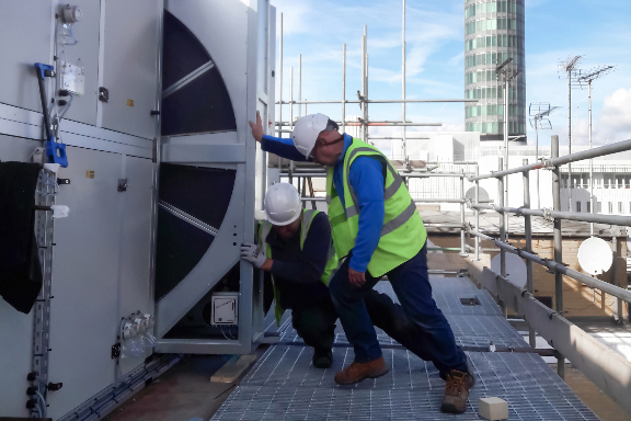 Two engineers installing a Flat Pack AHU in London W1